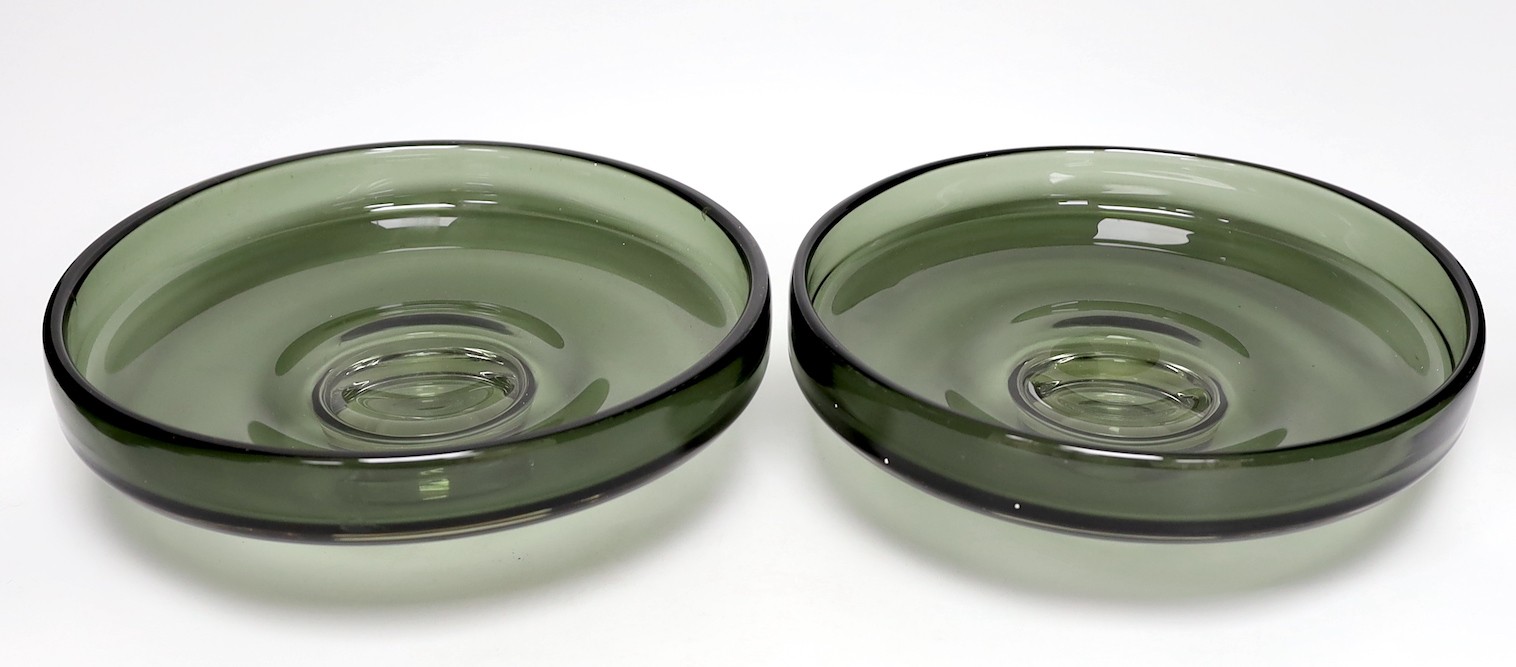 A pair of Scandinavian green glass dishes, 26cms diameter